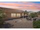 Large backyard with desert landscaping, a covered patio, and outdoor seating, perfect for entertaining at 10428 Villa Ridge Dr, Las Vegas, NV 89134