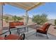 Well-maintained backyard features a covered patio, gravel landscaping, and mountain views at 10428 Villa Ridge Dr, Las Vegas, NV 89134
