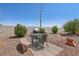 Cozy backyard patio area featuring a grill, seating, and low-maintenance desert landscaping at 10428 Villa Ridge Dr, Las Vegas, NV 89134
