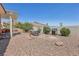 Landscaped backyard includes a built-in grill, gravel and covered patio, perfect for entertaining at 10428 Villa Ridge Dr, Las Vegas, NV 89134