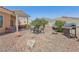 Spacious backyard features a covered patio, gravel landscaping, and built-in grill at 10428 Villa Ridge Dr, Las Vegas, NV 89134