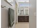 Bathroom with tile floors, a granite-topped dark wood vanity, and a towel bar with hanging towel at 10428 Villa Ridge Dr, Las Vegas, NV 89134