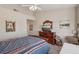 Spacious bedroom featuring a ceiling fan, carpet flooring, and a classic wood dresser with mirror at 10428 Villa Ridge Dr, Las Vegas, NV 89134