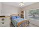 A bedroom features a wooden bed frame and a window at 10428 Villa Ridge Dr, Las Vegas, NV 89134