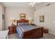 Spacious bedroom with a ceiling fan, carpet flooring, and classic wood bedroom furniture at 10428 Villa Ridge Dr, Las Vegas, NV 89134