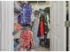 Walk-in closet with wire shelving and rods, filled with clothing and accessories at 10428 Villa Ridge Dr, Las Vegas, NV 89134