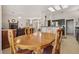 Comfortable dining area with a round wooden table and views of the open-concept living spaces and kitchen at 10428 Villa Ridge Dr, Las Vegas, NV 89134