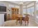 Cozy dining area with ample natural light, complemented by classic wooden furniture and an open layout at 10428 Villa Ridge Dr, Las Vegas, NV 89134