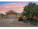 Charming single-story home featuring a well-manicured front yard, desert landscaping, and a two-car garage at 10428 Villa Ridge Dr, Las Vegas, NV 89134
