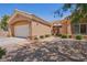 Single-story home featuring desert landscaping, an attached garage, and a covered entrance at 10428 Villa Ridge Dr, Las Vegas, NV 89134