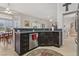 Well-appointed kitchen with stainless steel dishwasher, dark cabinetry, and an eat-in counter open to the dining area at 10428 Villa Ridge Dr, Las Vegas, NV 89134