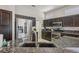 A kitchen features stainless steel appliances, dark wood cabinets, and granite countertops at 10428 Villa Ridge Dr, Las Vegas, NV 89134