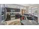 A spacious kitchen boasts stainless steel appliances, dark wood cabinetry, and granite countertops at 10428 Villa Ridge Dr, Las Vegas, NV 89134