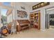 A living room with a piano and bookcase near a bright window at 10428 Villa Ridge Dr, Las Vegas, NV 89134