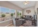 Bright living area with natural light, features a comfortable sofa and clear view of the landscaped backyard at 10428 Villa Ridge Dr, Las Vegas, NV 89134