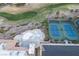 Aerial view showcasing community's pool, tennis courts, green spaces, well-maintained landscaping, and parking at 10513 Shanna Trellis Ave, Las Vegas, NV 89144