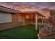 Relaxing covered patio and backyard space with artificial turf and decorative patio at 10513 Shanna Trellis Ave, Las Vegas, NV 89144
