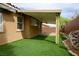 Covered patio featuring artificial turf and rock landscaping at 10513 Shanna Trellis Ave, Las Vegas, NV 89144