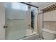 Bathroom featuring tiled shower and tub with glass door, sink and toilet at 10513 Shanna Trellis Ave, Las Vegas, NV 89144