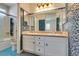 Bathroom with double sinks, decorative tile and glass enclosed shower and tub at 10513 Shanna Trellis Ave, Las Vegas, NV 89144