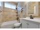 Bathroom with tile walls, a shower/tub combo, and white vanity at 10513 Shanna Trellis Ave, Las Vegas, NV 89144