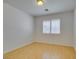Bright bedroom with hardwood floors, white walls, a window with plantation shutters at 10513 Shanna Trellis Ave, Las Vegas, NV 89144