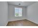 Bedroom with wood laminate floors and window at 10513 Shanna Trellis Ave, Las Vegas, NV 89144