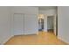 Bedroom featuring hardwood floors, a sliding door closet and bathroom access at 10513 Shanna Trellis Ave, Las Vegas, NV 89144