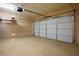 Garage featuring a two car garage door, storage racks and textured floors at 10513 Shanna Trellis Ave, Las Vegas, NV 89144