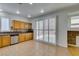 Bright kitchen featuring stainless appliances, wood cabinets, and sliding doors to the backyard at 10513 Shanna Trellis Ave, Las Vegas, NV 89144