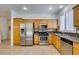 Bright kitchen featuring stainless steel appliances and lots of wood cabinets at 10513 Shanna Trellis Ave, Las Vegas, NV 89144