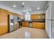 Bright kitchen with stainless appliances, light wood cabinetry and tile flooring at 10513 Shanna Trellis Ave, Las Vegas, NV 89144