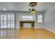 Bright living room featuring bamboo floors, stylish lighting, access to patio, and a decorative fireplace at 10513 Shanna Trellis Ave, Las Vegas, NV 89144