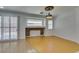 Bright and airy living room featuring bamboo floors, stylish lighting, and a charming decorative fireplace at 10513 Shanna Trellis Ave, Las Vegas, NV 89144
