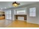 Bright living room featuring bamboo floors, stylish lighting, open kitchen access, and a decorative fireplace at 10513 Shanna Trellis Ave, Las Vegas, NV 89144