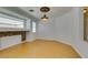 Bright and airy living room featuring bamboo floors, stylish lighting, and a charming decorative fireplace at 10513 Shanna Trellis Ave, Las Vegas, NV 89144