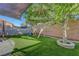 Lovely backyard featuring artificial turf, playground and ambient string lighting at 1069 Aspen Cliff Dr, Henderson, NV 89011