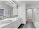 Beautiful bathroom featuring a large mirror, double sinks, and walk in shower at 1069 Aspen Cliff Dr, Henderson, NV 89011