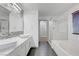 Modern bathroom featuring double sinks, a large mirror, and walk in shower at 1069 Aspen Cliff Dr, Henderson, NV 89011