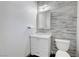 Stylish powder room boasts modern vanity with a glass bowl sink and unique tile accent wall at 1069 Aspen Cliff Dr, Henderson, NV 89011
