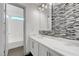Modern bathroom featuring a glass bowl sink, mosaic tile, and tub-shower combo at 1069 Aspen Cliff Dr, Henderson, NV 89011