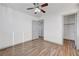A clean bedroom with wood-look floors, closet, and neutral wall color at 1069 Aspen Cliff Dr, Henderson, NV 89011