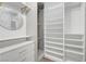 Walk-in closet featuring custom shelving, storage drawers, and wood floors at 1069 Aspen Cliff Dr, Henderson, NV 89011