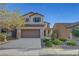 Charming two-story home with a well-manicured front yard and attached two-car garage, perfect for suburban living at 1069 Aspen Cliff Dr, Henderson, NV 89011