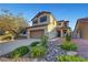 Charming two-story home with a well-manicured front yard and attached two-car garage, perfect for suburban living at 1069 Aspen Cliff Dr, Henderson, NV 89011