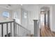 Upstairs hallway with light fixtures and natural light; views to front and back at 1069 Aspen Cliff Dr, Henderson, NV 89011