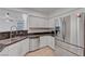 Modern kitchen featuring stainless steel appliances, bright cabinets, and stone countertops at 1069 Aspen Cliff Dr, Henderson, NV 89011