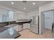 Stylish kitchen featuring stainless steel appliances, white cabinets, and stone countertops at 1069 Aspen Cliff Dr, Henderson, NV 89011