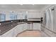 Modern kitchen featuring stainless steel appliances, bright cabinets, and stone countertops at 1069 Aspen Cliff Dr, Henderson, NV 89011