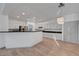 Modern kitchen with white cabinetry, dark countertops, stainless steel appliances and a stylish pendant light at 1069 Aspen Cliff Dr, Henderson, NV 89011